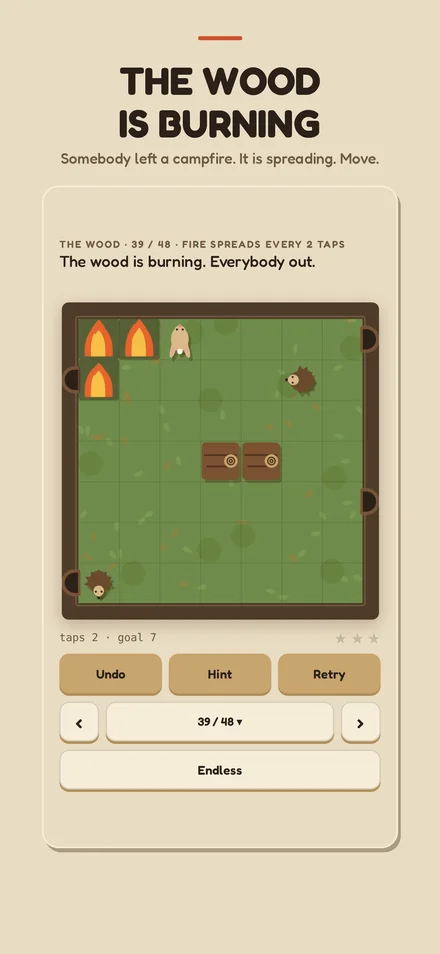 The wood, with a fire spreading across the board